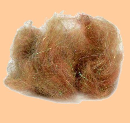 A pile of brown hair on top of an orange background.