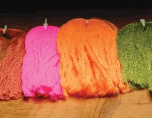 A group of yarn sitting on top of a wooden table.