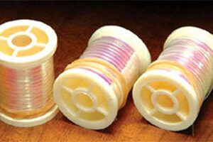 A group of four plastic spools with different colors.