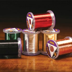 A group of spools of thread sitting on top of a table.